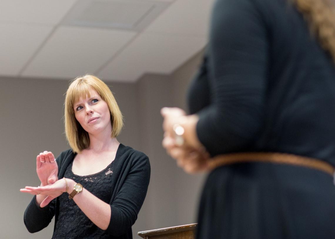 student engaging with instructor in Sign Language course