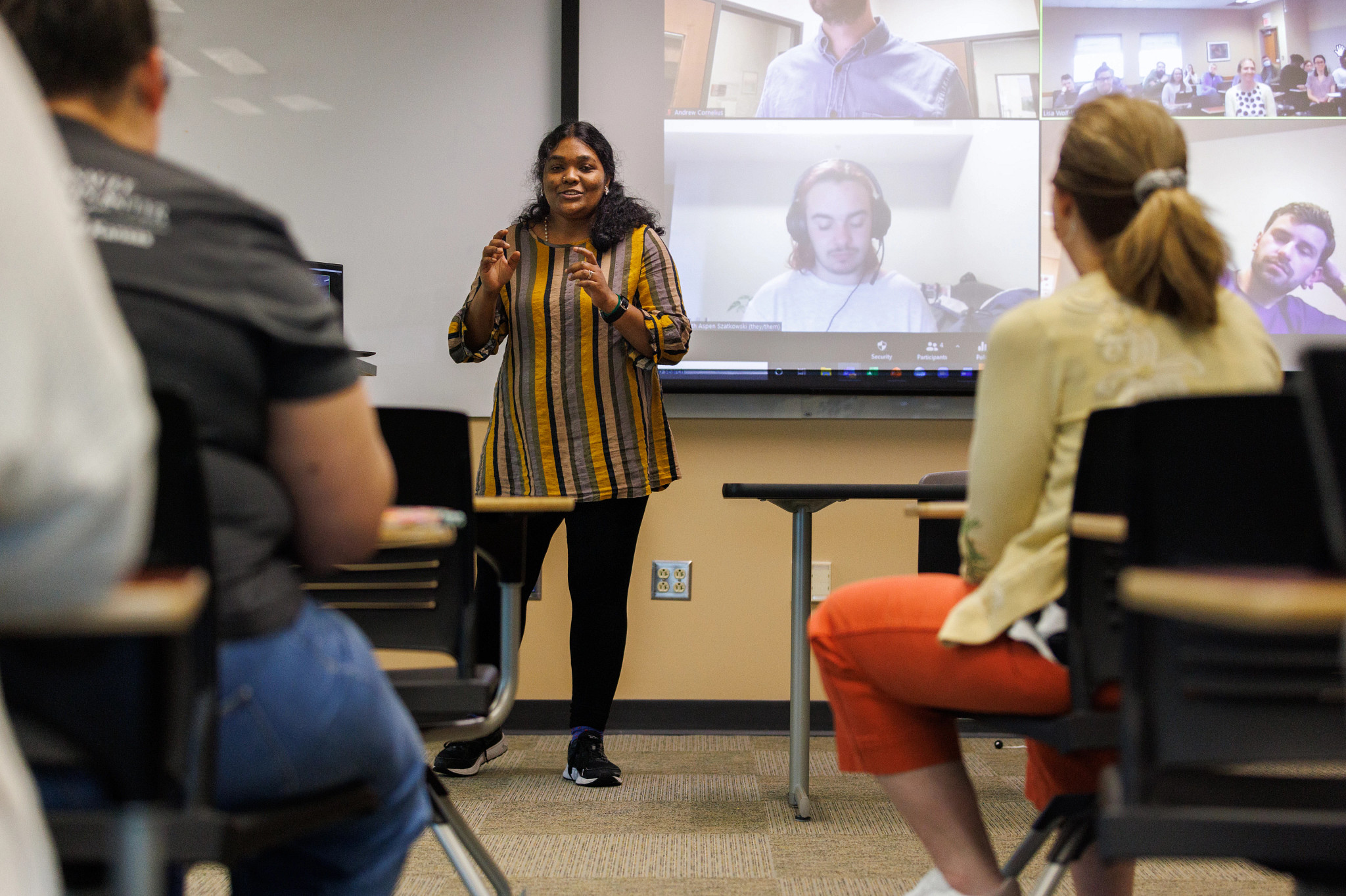 A student is giving a presentation in front of a classroom