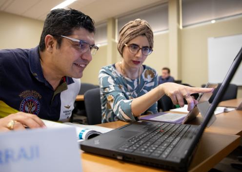 Two individuals in 1-on-1 Academics session at Edwards Campus in class doing project with a laptop