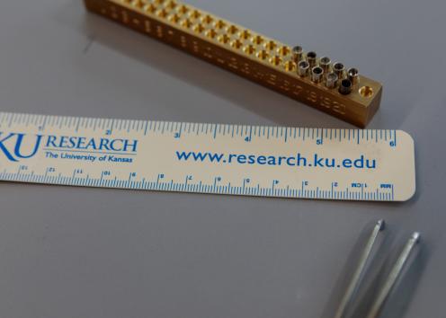 a ruler with KU Research the University of Kansas printed on it along with www.research.ku.edu